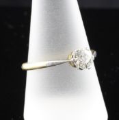 An 18ct gold and platinum solitaire diamond ring, the round cut diamond with an estimated weight