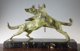 A 1930`s green patinated spelter figure group of two dogs, on a green serpentine marble base, signed