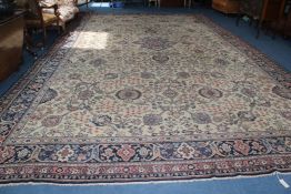 A large European carpet, with central foliate medallion in a field of scrolling foliage, on an ivory