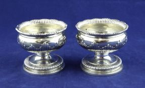A pair of early Victorian silver pedestal table salts, by The Barnards, with demi fluted leaf