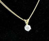 A modern 18ct gold and solitaire diamond pendant, the stone approximately estimated at 0.40ct.