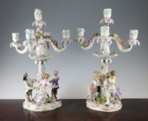 A pair of Dresden porcelain figural candelabra, c.1880, each base modelled with four children