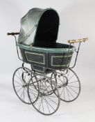 A Victorian double ended wrought iron push pull pram, with spoked wheel and green leather interior
