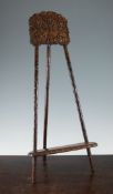 A Chinese export rosewood easel stand, late 19th / early 20th century, the crest carved with