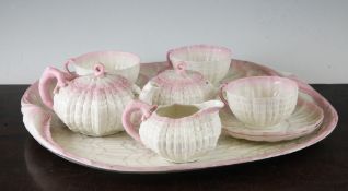 A Belleek first period cabaret tea set, late 19th century, each piece of shell form with pink tinted