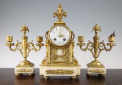 An early 20th century French ormolu and white marble clock garniture, the clock with floral