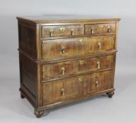 An early 18th century walnut and herringbone inlaid split section chest, with two short and three