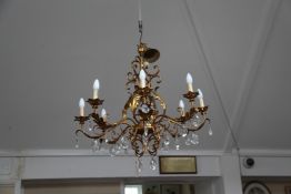 A large gilt metal and lustre eight branch electrolier, with facet cut pear shaped drops and