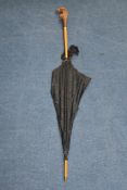 An Edwardian S. Fox & Co Paragon lady`s parasol, with articulated carved parrot handle, 42.5in.