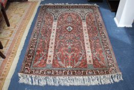 A Persian part silk prayer rug, with arches within a field of scrolling foliage and five row border,