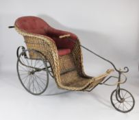 A Victorian wicker invalids / bath chair, with burgundy patterned buttoned upholstery and three