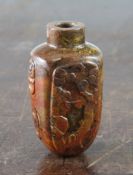 A Chinese jasper snuff bottle, carved in low relief with a luohan holding a bottle with a bat