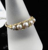 A late Victorian 18ct gold, split pearl & diamond half hoop ring, with pierced scroll setting,