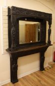 A Victorian carved oak mirror back fire surround, carved with figural pilasters, flowers and
