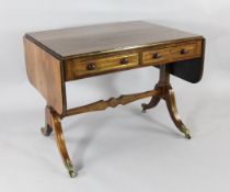 A Regency rosewood and brass strung sofa table, with four drawers opposing four further drawers,