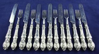 Six matched pairs of Victorian silver dessert eaters, with embossed scroll handles and one other