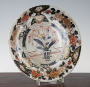 A Japanese Arita porcelain dish, late 17th/early 18th century, decorated in Imari pallet with a vase