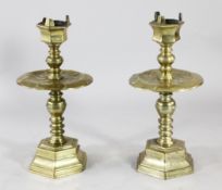 Two large Dutch Heemskerk style brass candlesticks, with hexagonal sconces, wide circular drip