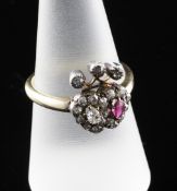 An 18ct ruby and diamond set twin heart dress ring, with three individually set diamonds above, size