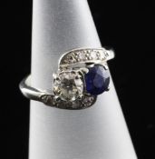 A 14ct white gold, sapphire and diamond crossover ring, with diamond set shoulders, size I.