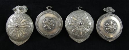 An Ottoman Islamic belt buckle, with embossed floral decoration and mounted with coloured stones,