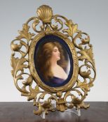 A Continental porcelain oval portrait plaque, late 19th century, painted with the portrait of an