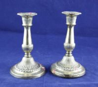 A pair of George III silver candlesticks, with turned tapering demi fluted stems, John & Thomas