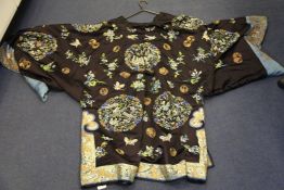 A Chinese embroidered silk and metal thread robe, early 20th century, decorated with medallions of