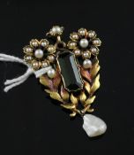 An early 20th century 18ct gold, tourmaline, seed and baroque pearl drop pendant, of foliate design,