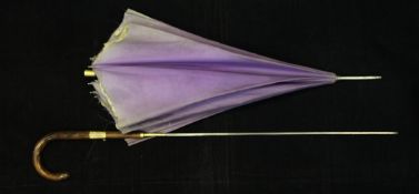An unusual Edwardian lady`s parasol sword stick, with lilac silk parasol and shaped olive wood