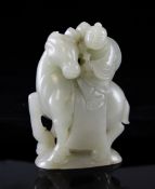 A large Chinese celadon jade group of a boy riding a qilin, on a domed base, the stone of good