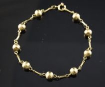 An 18ct gold ball and baton link bracelet, 8 grams, 8.25in.