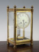 An early 20th century French brass four glass mantel clock, with arabic dial and mercury pendulum,