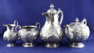An early Victorian Scottish silver three piece tea set, of spherical form, embossed with foliate