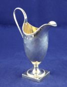 A George III silver helmet shaped cream jug, with beaded borders, on square foot, Hester Bateman? (