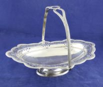 A late Victorian pierced silver oval pedestal cake basket, with foliate engraved decoration and