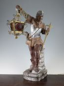 A Continental painted terracotta table lamp, modelled as a medieval soldier holding a lantern,