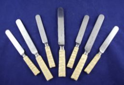 A set of twelve Victorian elephant tooth handled table knives and twelve matching dessert knives,