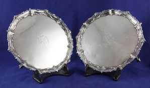 A pair of George III silver salvers, of shaped circular form, with cast scroll and gadrooned borders