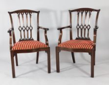 A set of six George III Chippendale style mahogany elbow chairs, with pierced Gothic arched backs