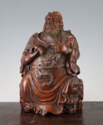 A Chinese bamboo seated figure of Guandi, wearing dragon robes, seated upon rocks, 10.9in.