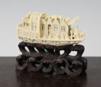 A Chinese export ivory model of a boat, early 20th century, carved in relief and open work with