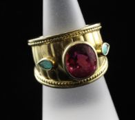 A Theo Fennell 18ct gold, pink and paraiba tourmaline dress ring, the central oval cut stones