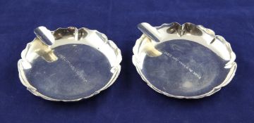 A pair of 20th century sterling silver ashtrays, by Cartier, of shaped circular form, both