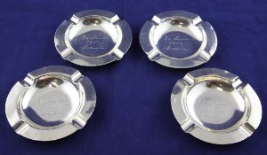A set of four 1950`s silver ashtrays, by Goldsmiths & Silversmiths Co Ltd, of circular form, with
