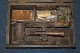 A vampire slaying kit, the stained pine box containing two stakes, a mallet, a bottle of holy water,
