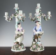 A pair of Sitzendorf figural candelabra, late 19th century, modelled with a lady and gentleman, each