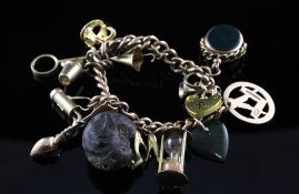 A 9ct gold curb link charm bracelet, with heart shaped padlock and hung with fourteen charms,