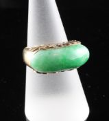A 14ct gold and jadeite ring, with foliate carved setting, size O.