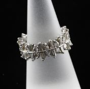 A white gold and diamond eternity ring, of "jagged" form, set with brilliant and baguette cut